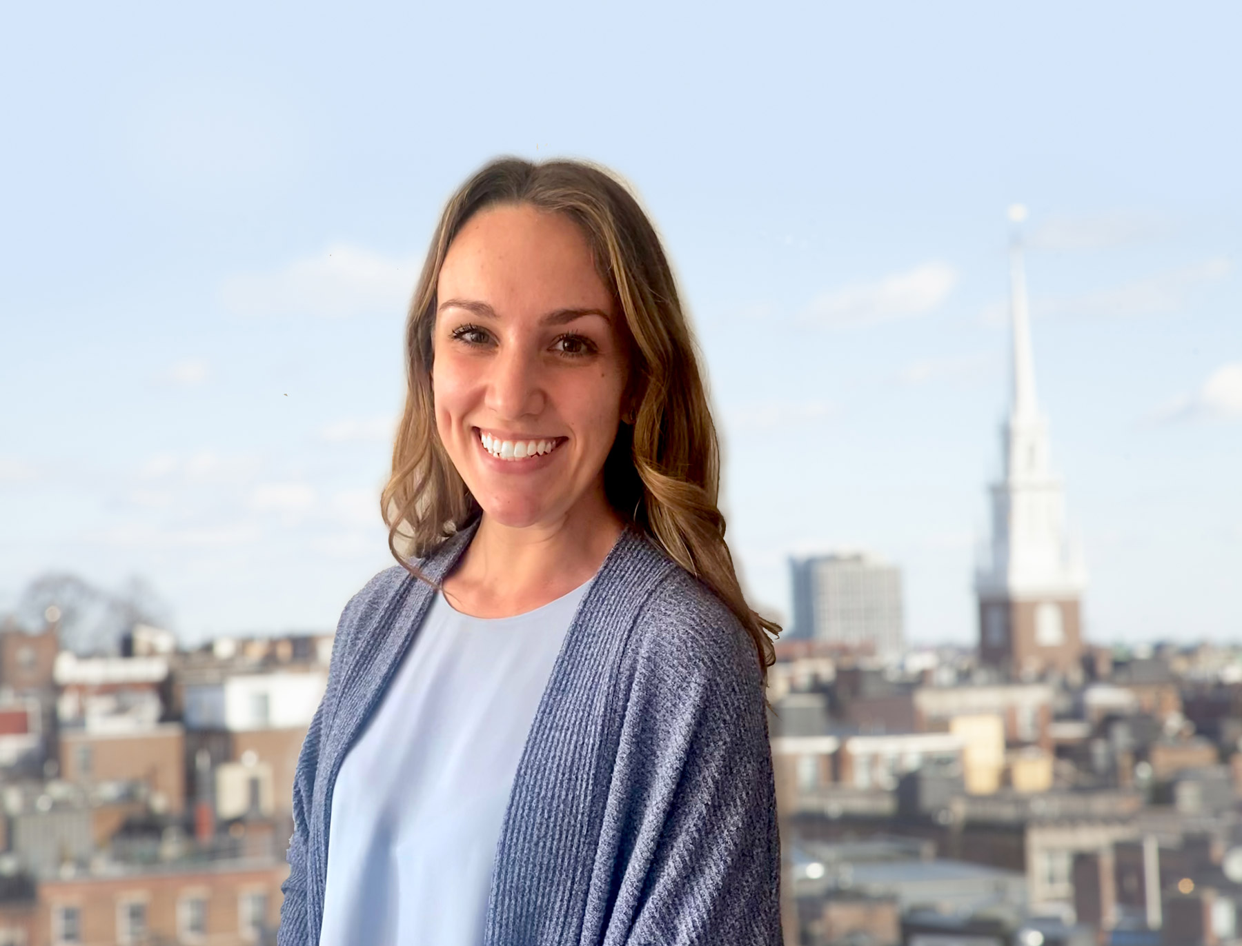 Headshot of Kate in front of Boston's north-end neighborhood.