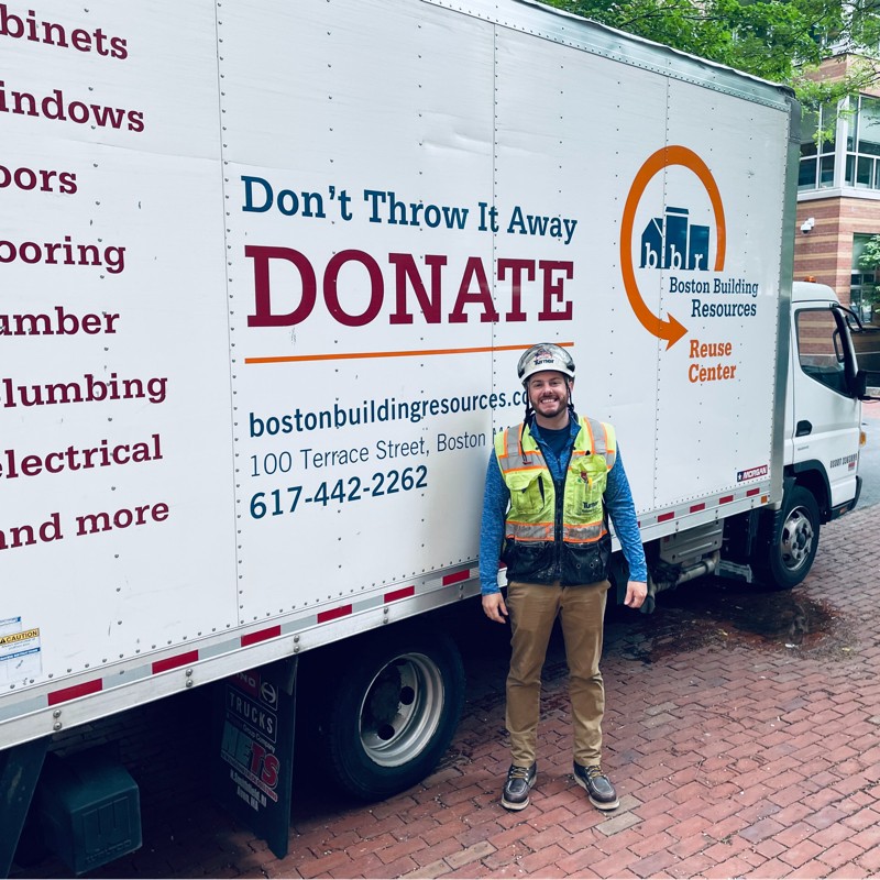 Dylan Malm standing in front of the Boston Building Services Truck during Appliance Donation