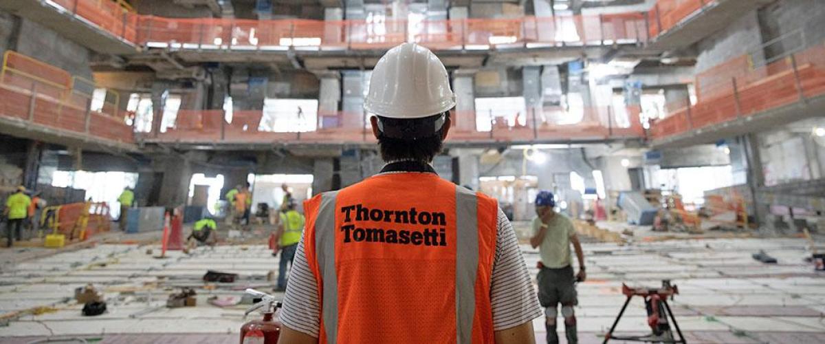 Man looking out at worksite wearing Thornton Tomasetti work vest
