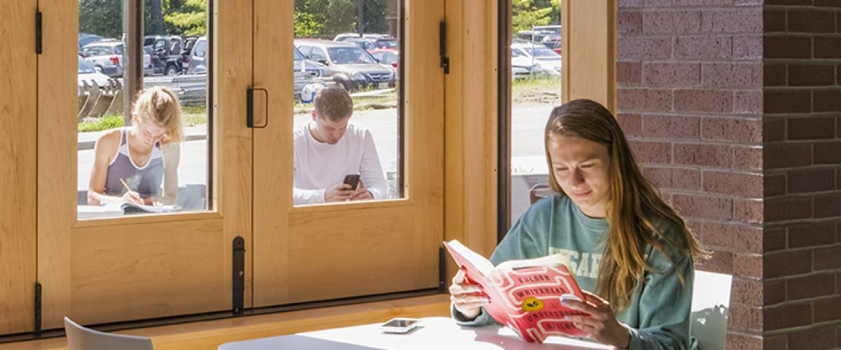 Photograph of women sitting at a cafe table in front of a window in the Williams Bookstore